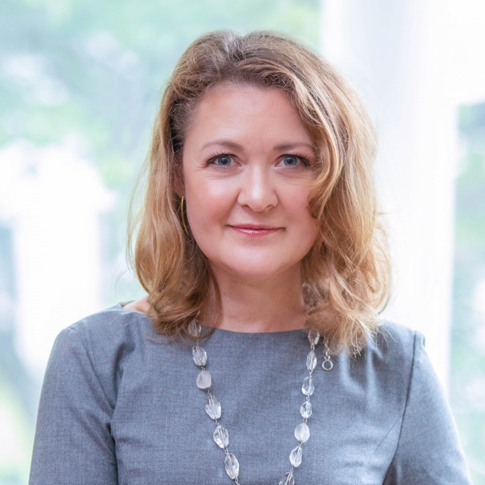 Christine Schlangen in a gray dress