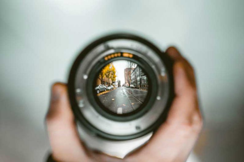 view of a city street brought to focus through a camera lens