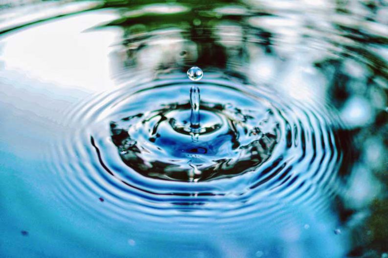 water drop making ripples that travel